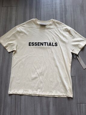 ESSENTIALS Men’s Cream Logo T-Shirt (Large)